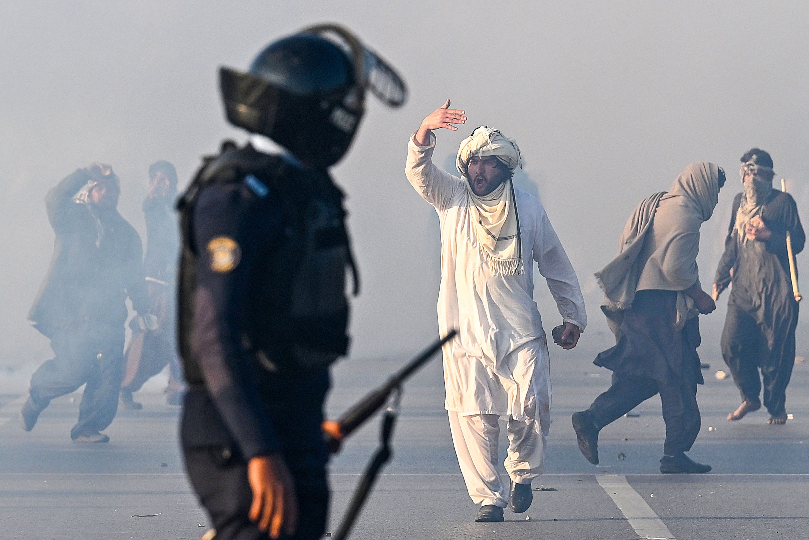 A supporter of Pakistan Tehreek-e-Insaf (PTI) party gestures after tear gas was fired by the police to disperse the crowd during a protest to demand the release of former prime minister Imran Khan in Islamabad, Pakistan, on November 26, 2024. (AFP/File)