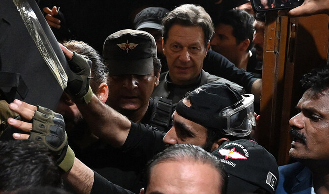 Pakistan’s former prime minister Imran Khan (C) leaves after appearing before a court for a protective bail in relation to two cases, in Lahore on March 21, 2023. (AFP/File)