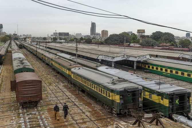 Policemen walk along trains stationed on a deserted platform at Karachi Cantonment railway station in Karachi, on March 26, 2020. (AFP/File)