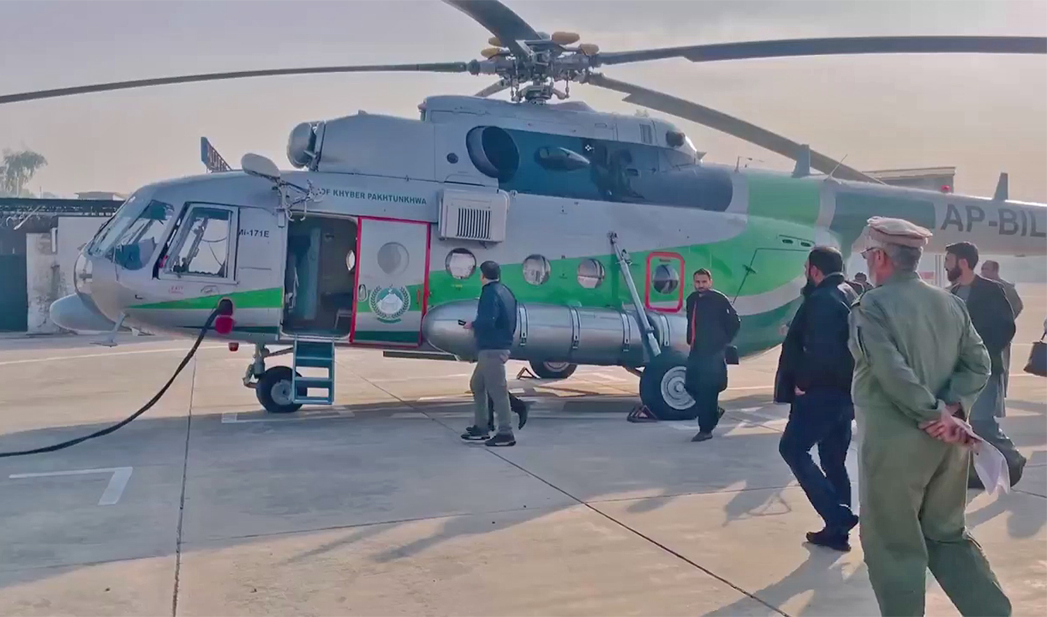 Officials gather around Khyber Pakhtunkhwa government’s MI-7 helicopter in Peshawar, Pakistan, on December 8, 2024 to transport essential medicines to the volatile Parachinar city in northwestern Kurram district. (@GovernmentKP/X)