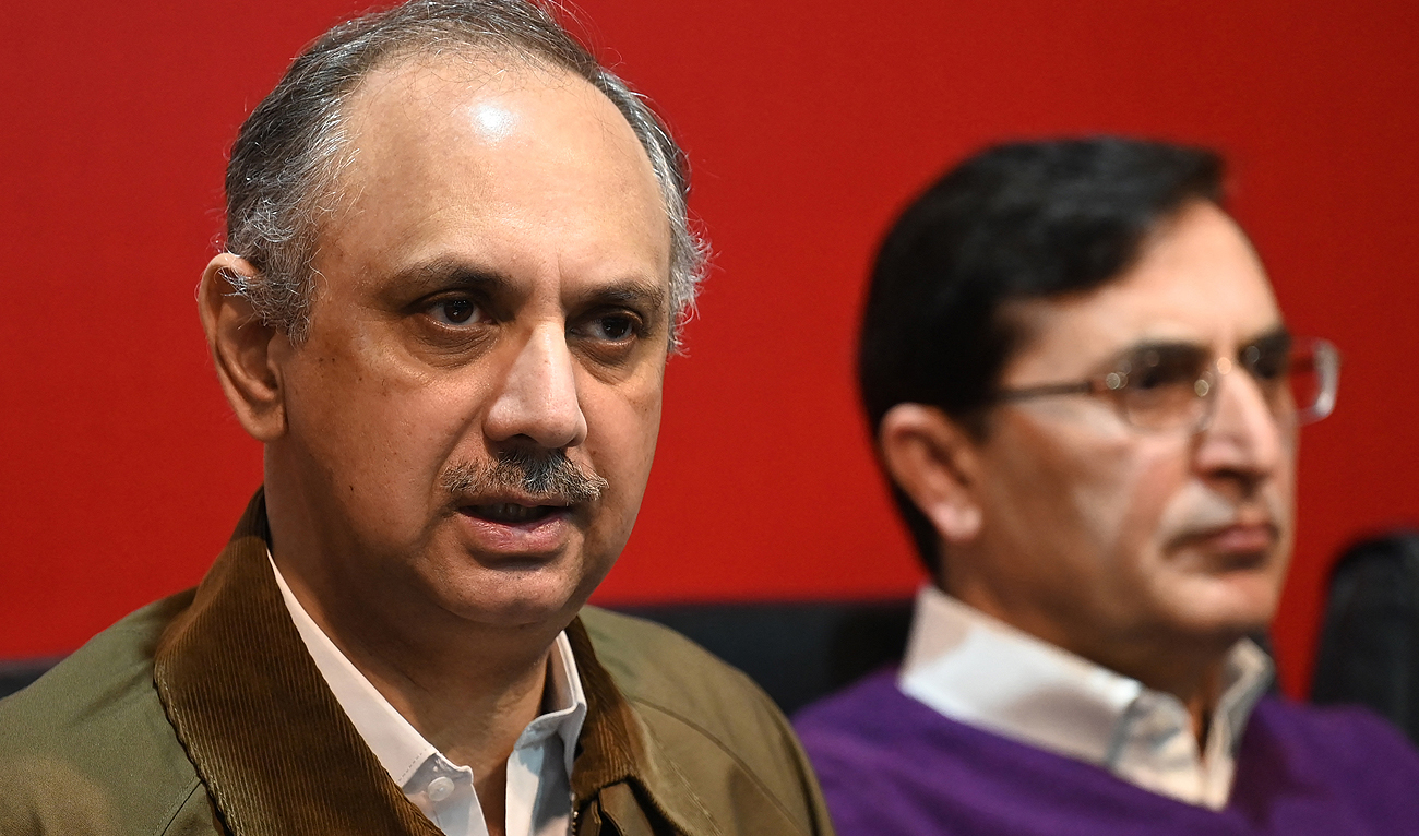 Former prime minister Imran Khan’s Pakistan Tehreek-e-Insaf (PTI) party leader Omar Ayub Khan (L) speaks during a press conference at PTI’s central secretariat in Islamabad on February 18, 2024. (AFP/File)