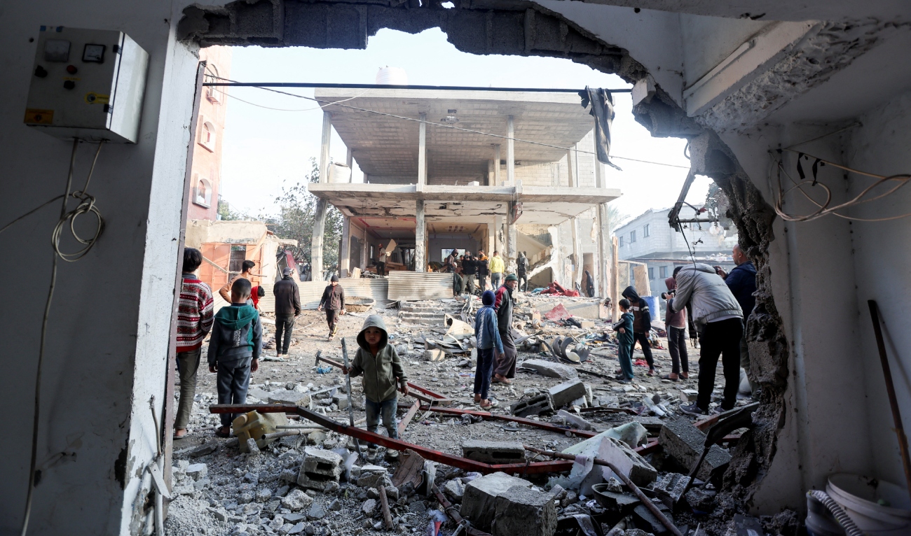 Palestinians inspect damage at the site of an Israeli strike on a house, amid the Israel-Hamas conflict, at the Nuseirat refugee camp in the central Gaza Strip on December 12, 2024. (REUTERS)