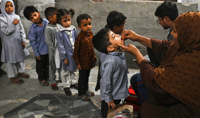 Health workers administer polio drops to children at a school during a vaccination campaign in Lahore, Pakistan, on October 28, 2024. (AFP/File)