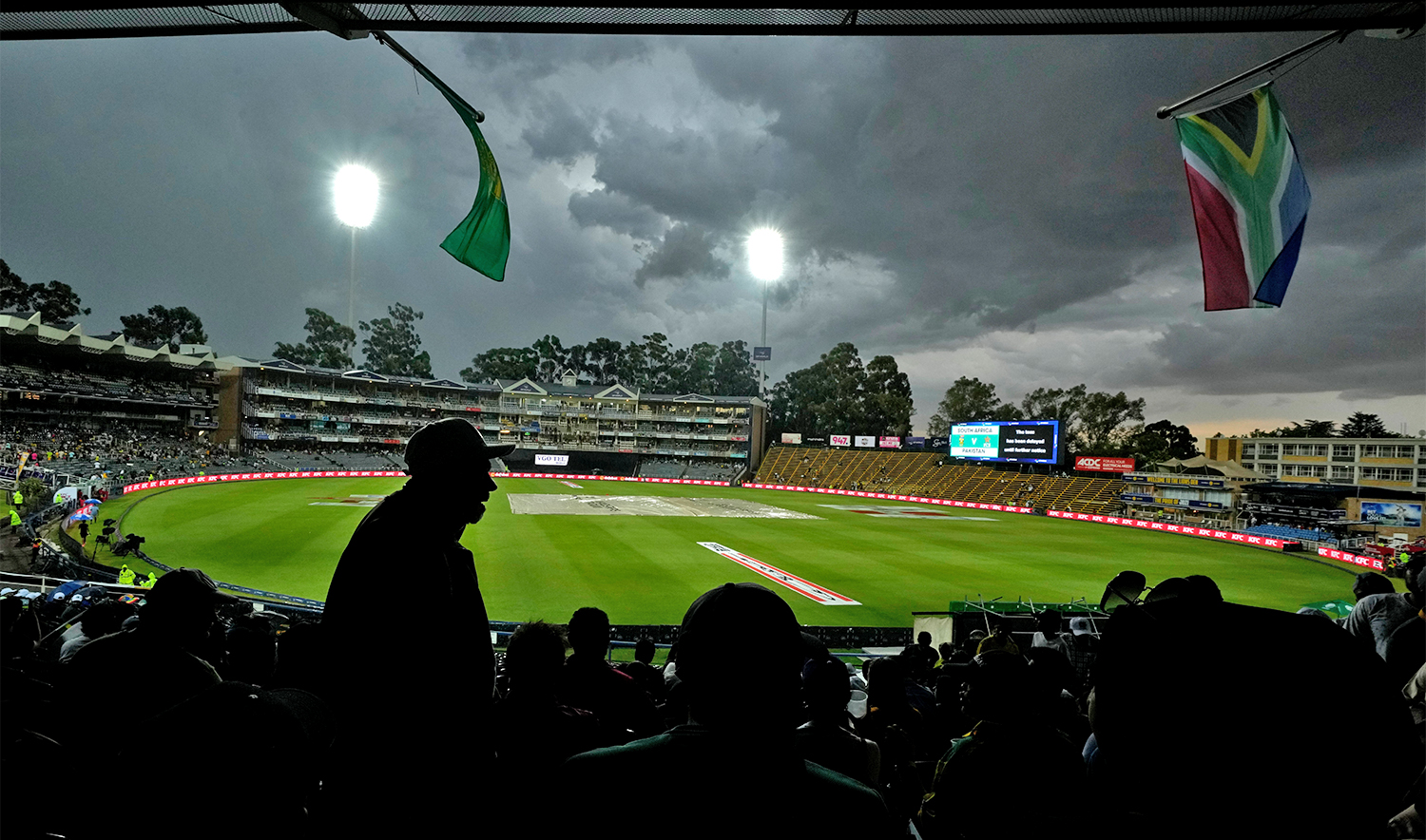 Fans wait for the toss that has been delayed due to lightning around and the rain, during for the third T20 International cricket match between South Africa and Pakistan, at the Wanderers Stadium in Johannesburg, South Africa, on December 14, 2024. (AP)