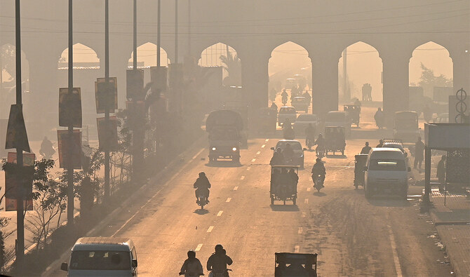 Commuters move along a road amid heavy smoggy conditions in Lahore on November 25, 2024. (AFP/File)