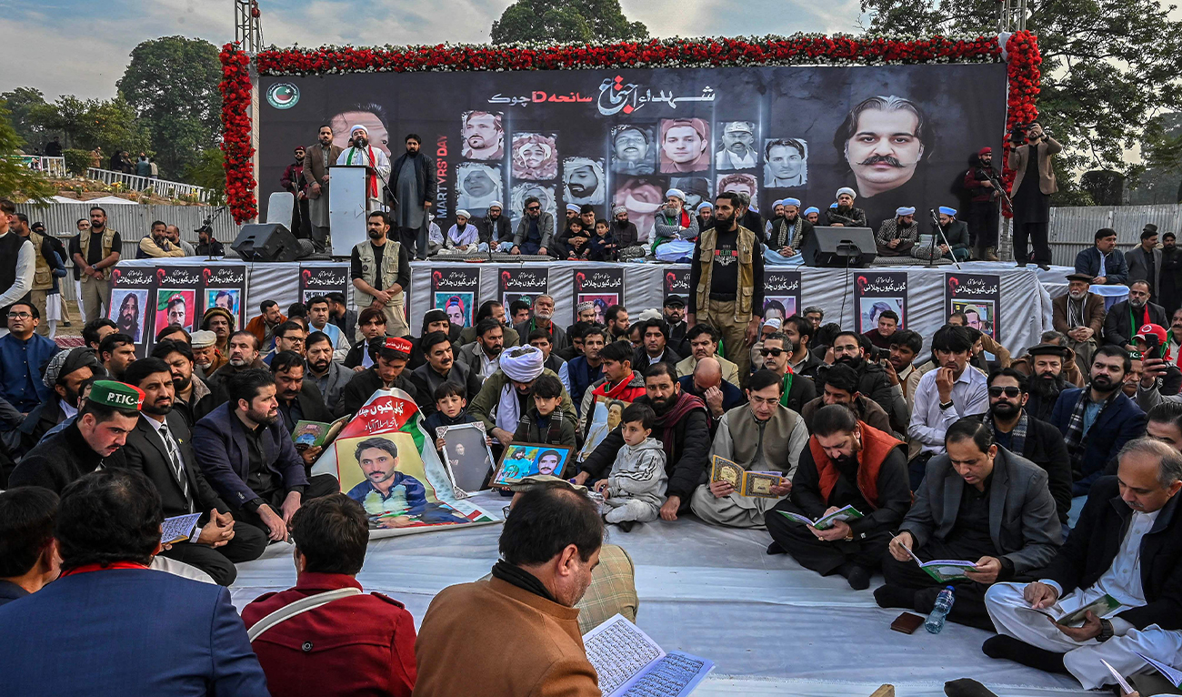 Supporters of jailed former prime minister Imran Khan’s Pakistan Tehreek-e-Insaf (PTI) party recite verses of the Holy Qur’an as they observe Martyrs’ Day to honor those who allegedly died during last month’s protest, in Peshawar on December 15, 2024. (AFP)