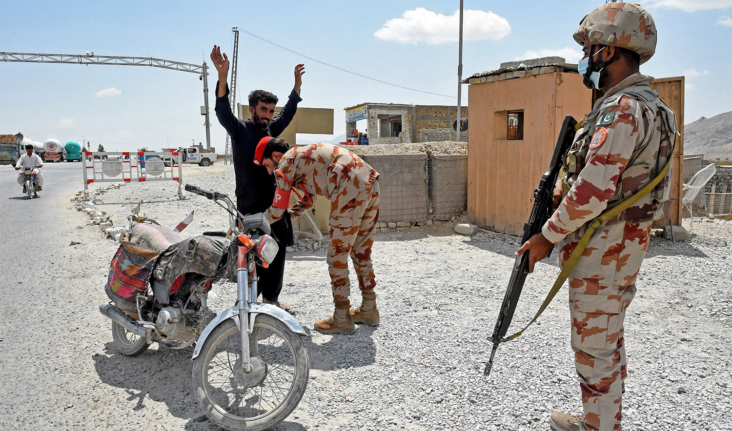 A Pakistani paramilitary ranger frisks a motorcyclist at a checkpoint a day after attacks by separatist militants on the outskirts of Quetta on August 27, 2024. (AFP/File)