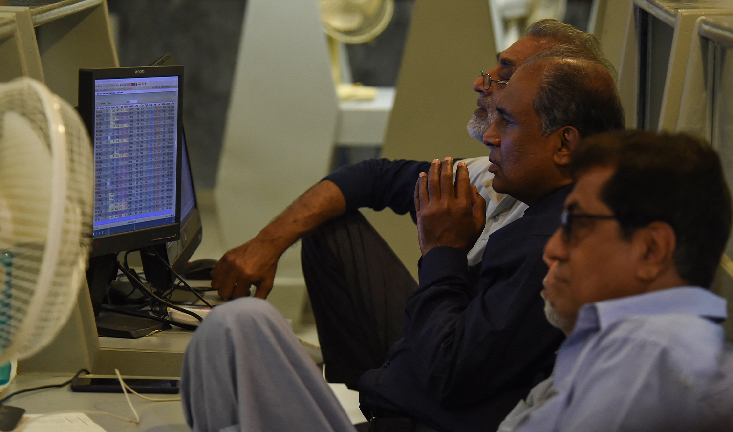 Stockbrokers look at the latest share prices at the Pakistan Stock Exchange in Karachi on February 9, 2023. (AFP/File)