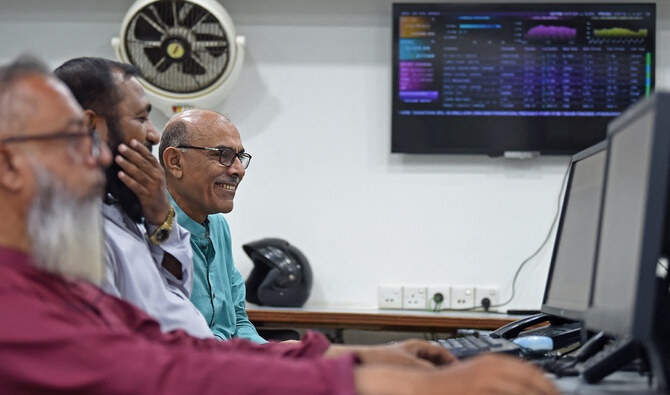 Stockbrokers monitor the latest share prices at the Pakistan Stock Exchange (PSX) in Karachi on July 3, 2023. (AFP/File)