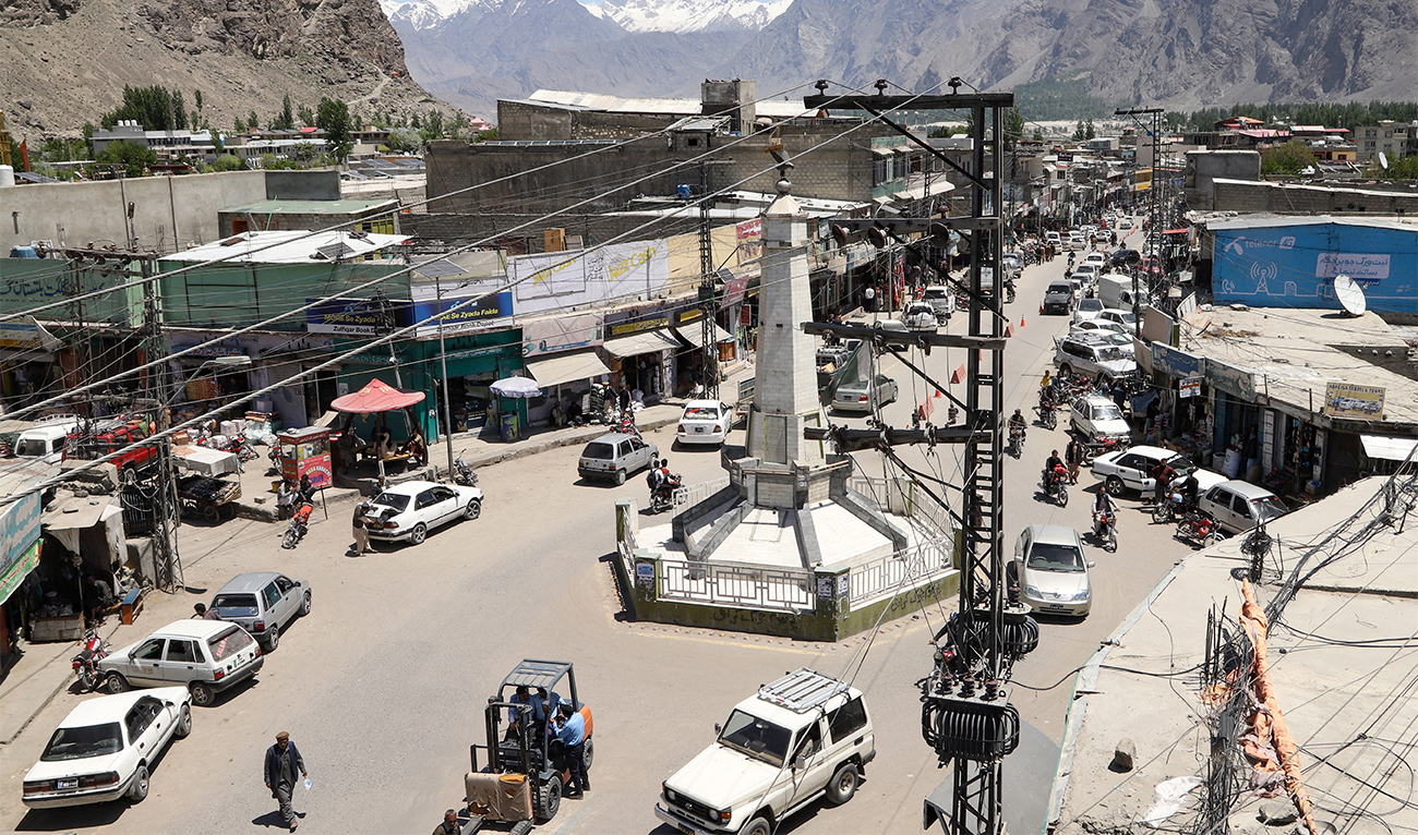 This photograph taken on May 9, 2024 shows commuters riding past electric poles installed along a street at Skardu in Pakistan's Gilgit-Baltistan region. (AFP/File)