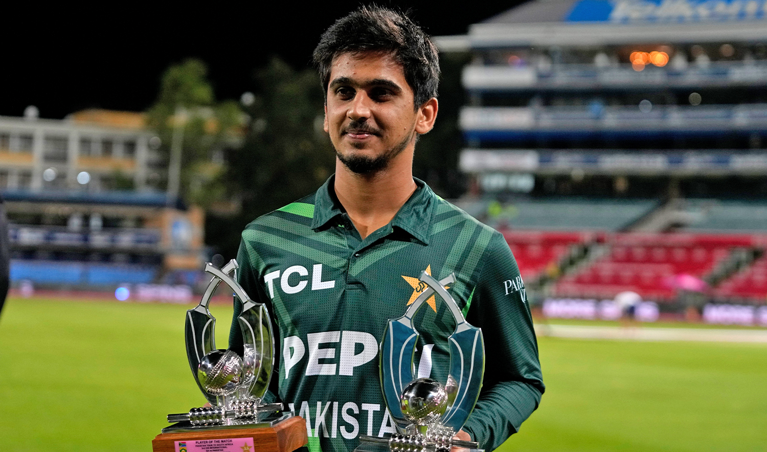 Pakistan's Saim Ayub holds the Player of the Match and Player of the Series trophies following the third International cricket match between South Africa and Pakistan, at the Wanderers stadium in Johannesburg, South Africa, on December 22, 2024. (AP)