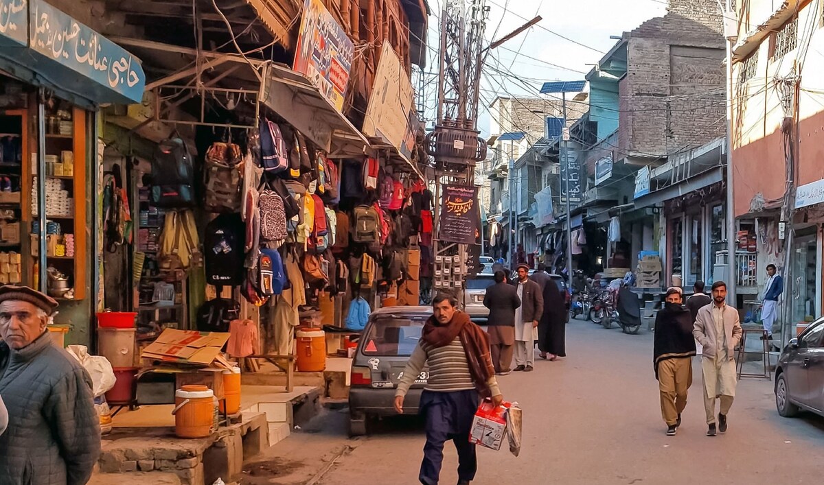 This photograph taken on December 3, 2024, shows local residents walking across a market reopened after sectarian clashes in Parachinar, Khyber Pakhtunkhwa province. (AFP/File)