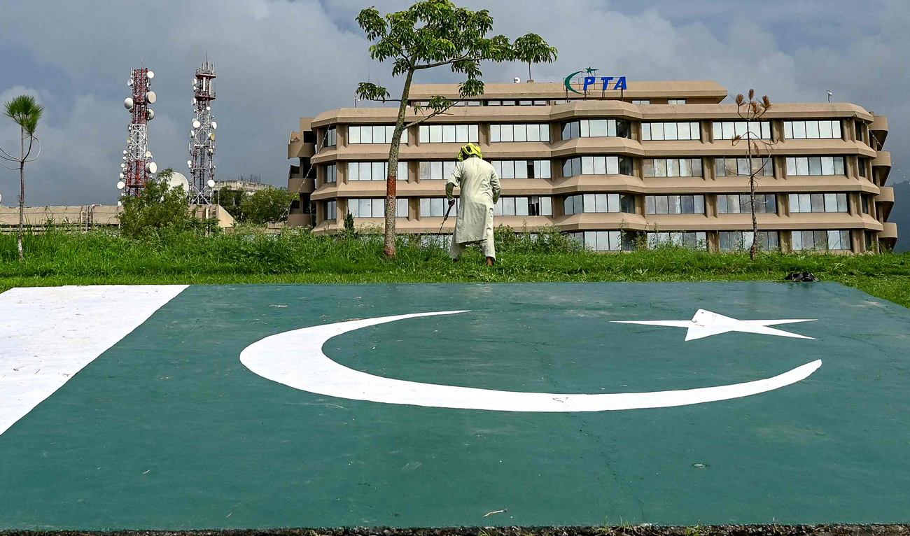 People work near the Pakistan Telecommunication Authority (PTA) headquarters building in Islamabad on August 16, 2024. (AFP/File)