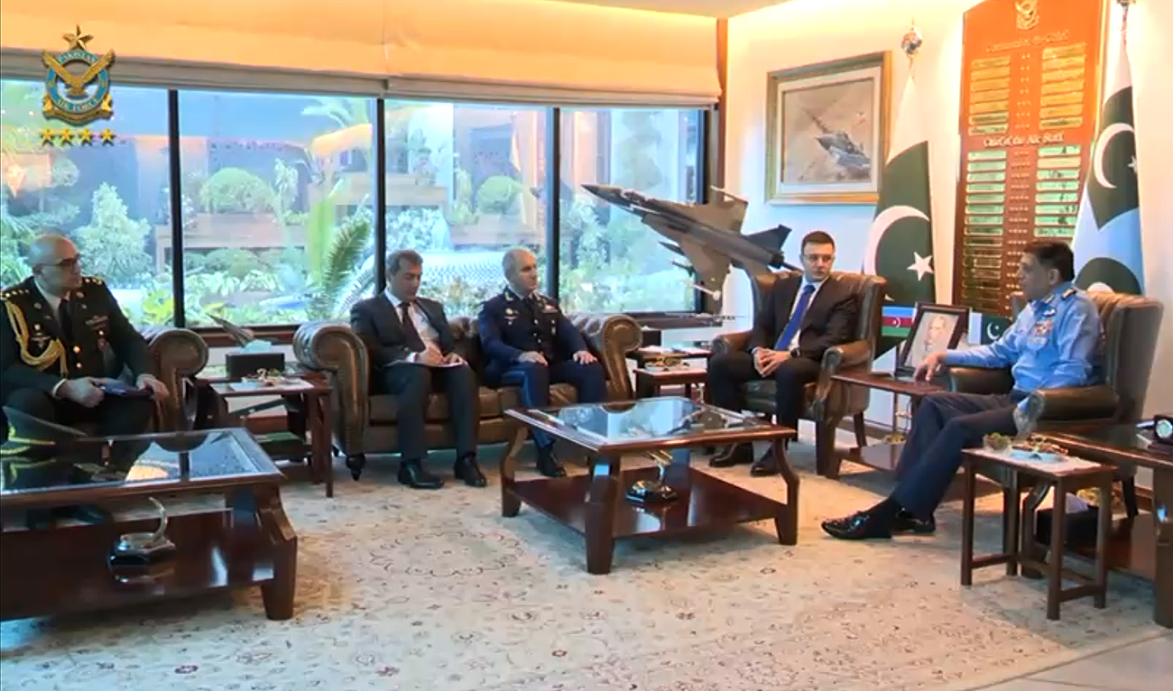 In this handout photograph, taken and released by Pakistan Air Force, a high-level Azerbaijani delegation, comprising Deputy Defense Minister Agil Gurbanov (2R), gestures during a meeting with Pakistan Air Chief Marshal Zaheer Ahmed Baber Sidhu (R) at the Air Headquarters in Islamabad on December 23, 2024.