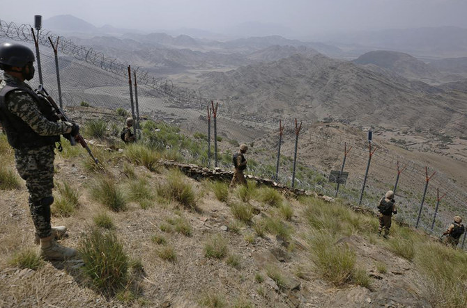 In this file photo, taken on August 3, 2021, Pakistan Army troops patrol along the fence on the Pakistan Afghanistan border at Big Ben hilltop post in Khyber district. (AP/File)