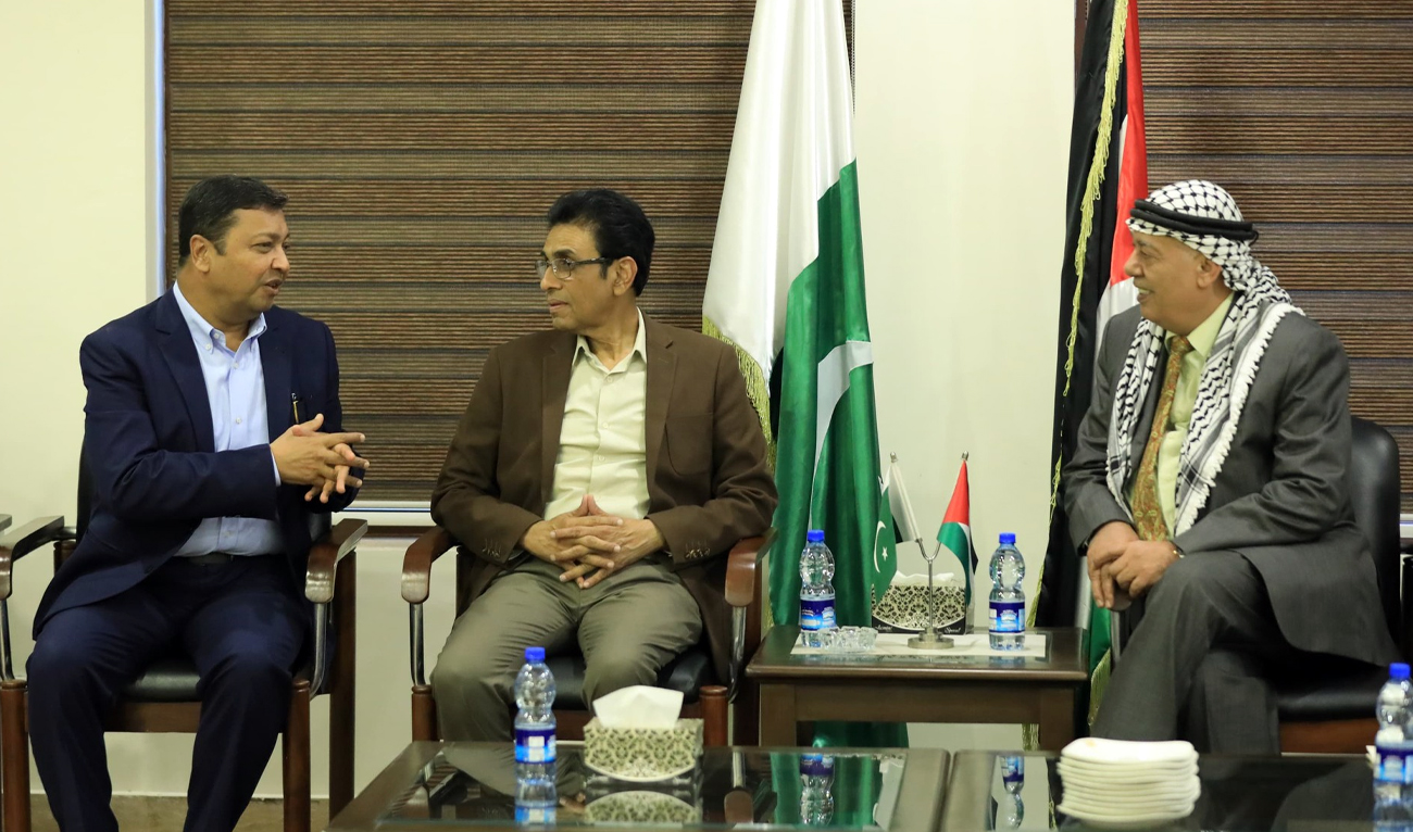 This handout photograph released by the OIC’s Standing Committee on Scientific and Technological Cooperation (COMSTECH) shows COMSTECH Coordinator General Dr. Muhammad Iqbal Choudhary (left) speaks during a meeting with Pakistan’s Education Minister Dr. Khalid Maqbool Siddiqui (center) and Palestinian Ambassador to Pakistan Dr. Zuhair Zaid at the Palestinian embassy in Islamabad, Pakistan, on December 26, 2024. (COMSTECH)