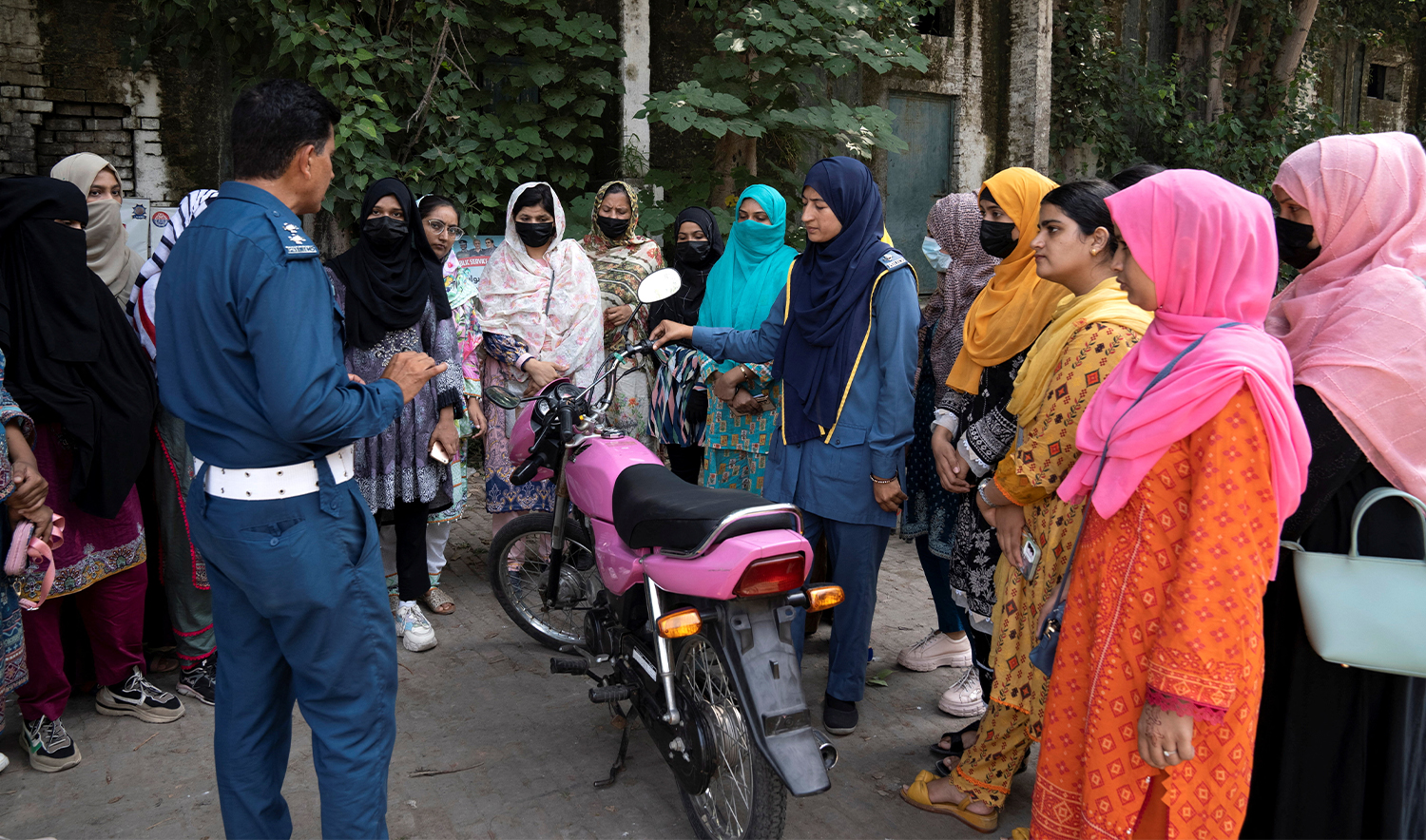 Traffic wardens familarize a group of women with components of a motorbike, during a training session as part of the "Women on Wheels" program organised by the traffic police department in Lahore, Pakistan, on October 1, 2024. (REUTERS)