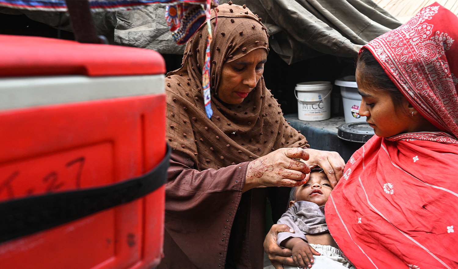 A health worker administers polio drops to a child during a door-to-door vaccination campaign in Lahore on October 28, 2024. (AFP/File)