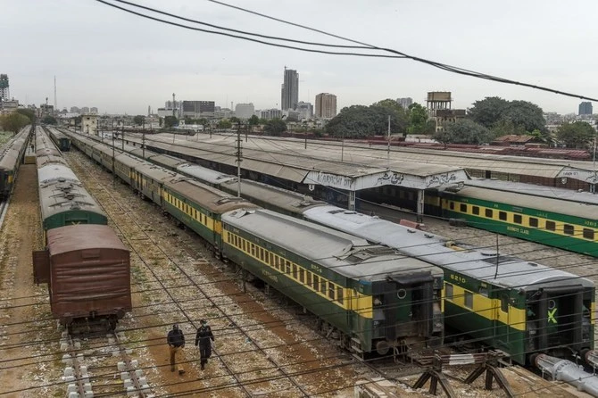 Policemen walk along trains stationed on a deserted platform at Karachi Cantonment railway station in Karachi, on March 26, 2020. (AFP/File)