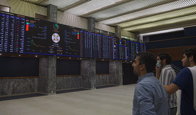 Stockbrokers watch an index board showing the latest share prices during a trading session at the Pakistan Stock Exchange (PSX) in Karachi on September 20, 2021. (AFP/File)