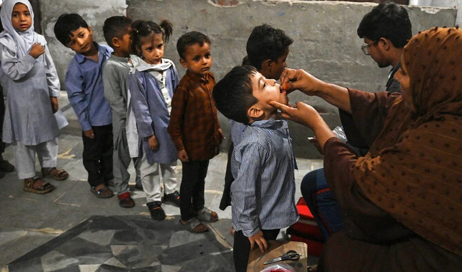 Health workers administer polio drops to children at a school during a vaccination campaign in Lahore, Pakistan, on October 28, 2024. (AFP/File)