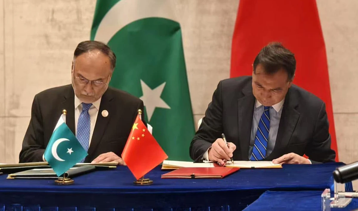 Pakistan’s planning minister Ahsan Iqbal and director of the China International Development Cooperation Agency (CIDCA), Luo Zhaohui (right), sign a climate cooperation agreement to implement an information and early warning system in Pakistan, in Kunming, China, on December 17, 2024. (Photo Courtesy: Ministry of Planning, Development and Special Initiatives, Pakistan)