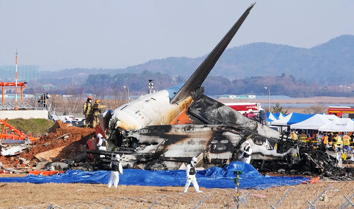 Firefighters and rescue team members work near the wreckage of a passenger plane at Muan International Airport in Muan, South Korea, on December 29, 2024. (AP)
