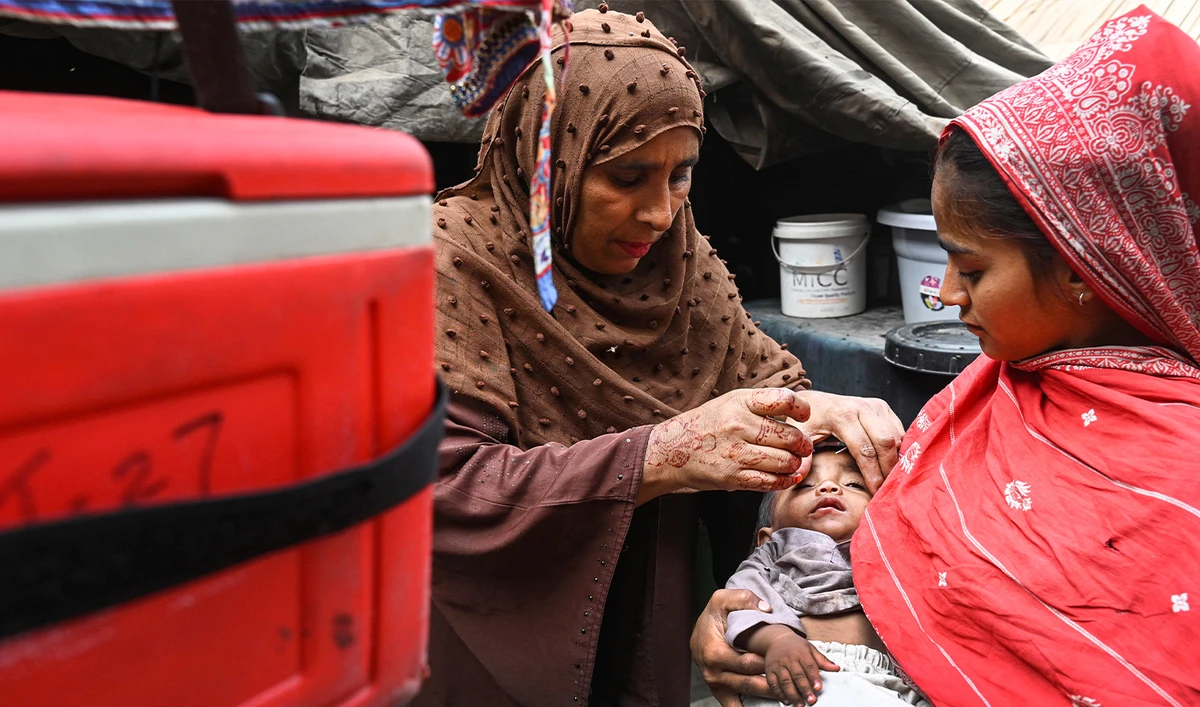 A health worker administers polio drops to a child during a door-to-door vaccination campaign in Lahore on October 28, 2024. (AFP/File)