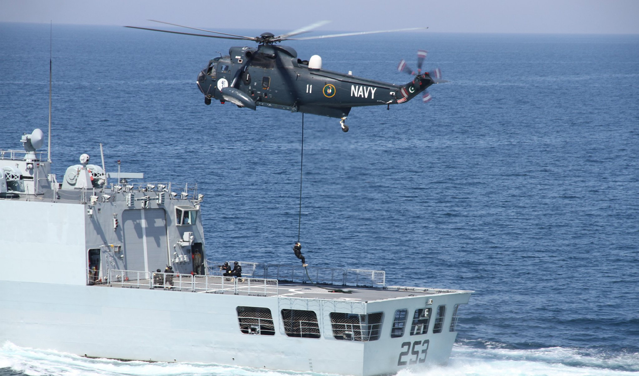 This handout photograph, released by Pakistan Navy on December 2, 2024, shows a military helicopter deploying marines onto a naval ship during a military exercise in the Arabian Sea. (Photo courtesy: Pakistan Navy)