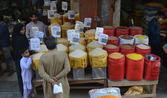 People buy pulses and grains at a wholesale market in Karachi, Pakistan, on February 1, 2023. (AFP/File)