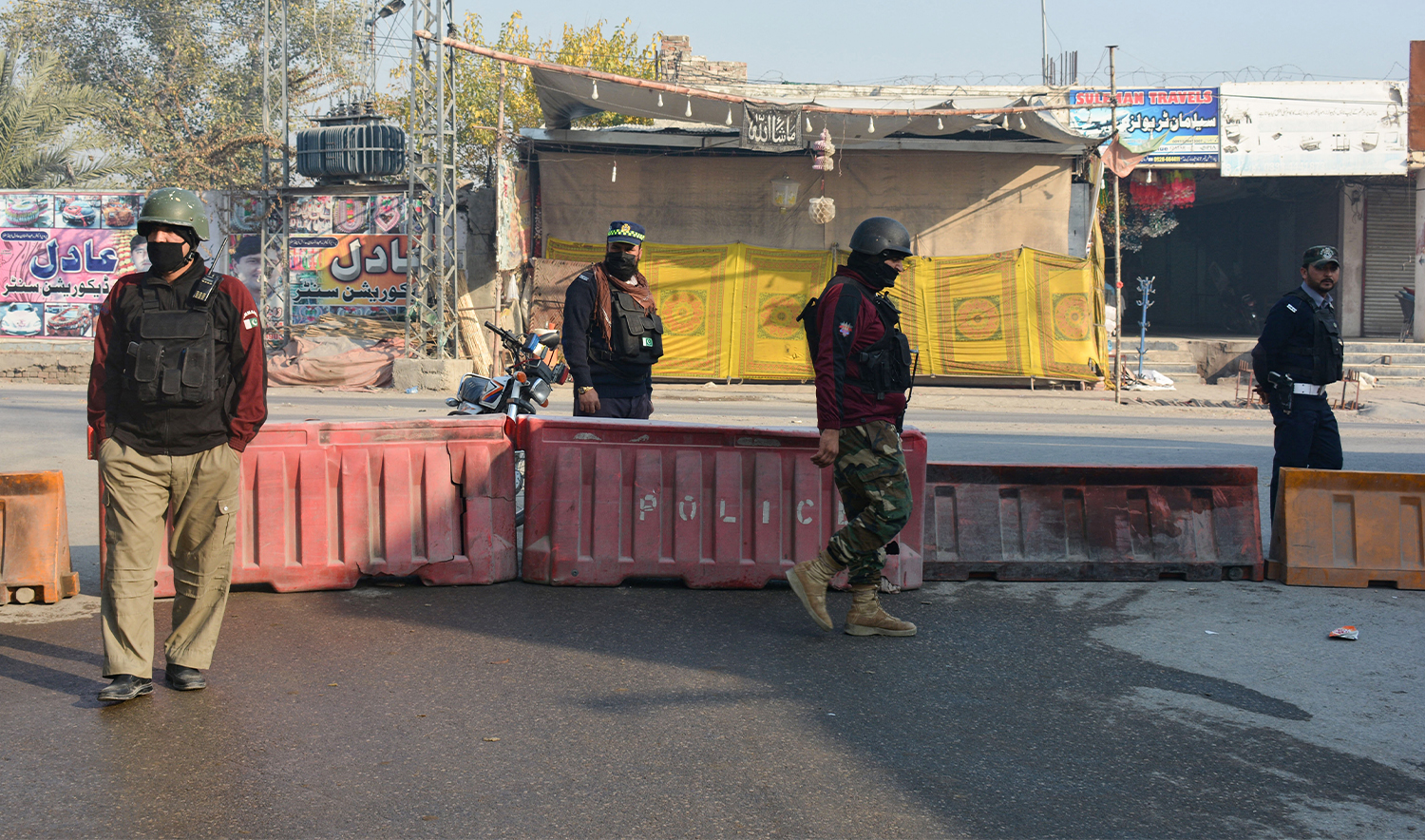 Police stand guard along a road in Bannu on December 21, 2022. (AFP/File)