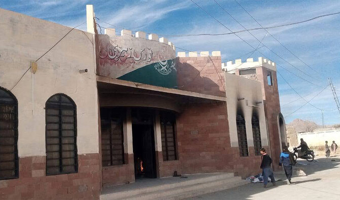 People walk outside the torched Levies station in Zehri, a small town in Pakistan’s Balochistan, on January 8, 2025. (Balochistan Police)