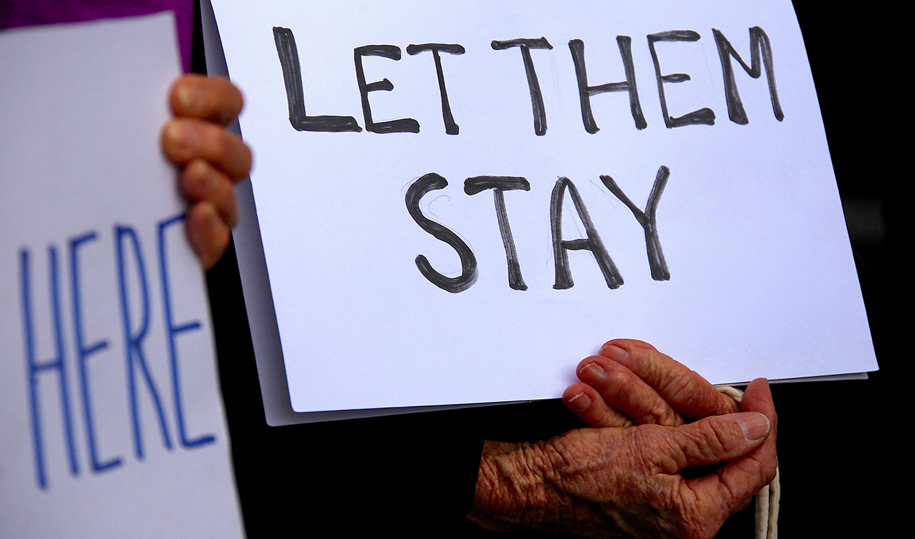 Refugee advocates hold signs as they protest against the detention of asylum seekers being held at Australian-run offshore detention centers located on Papua New Guinea’s Manus Island, and the South-Pacific island of Nauru, in central Sydney on August 31, 2017. (REUTERS/File)