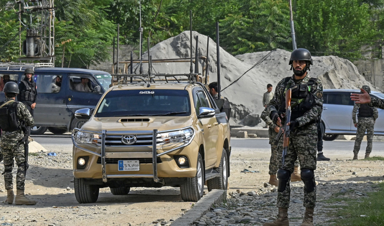 Security personnel stand guard at the site of a bomb blast in Bajaur district of Khyber-Pakhtunkhwa province, Pakistan, on July 31, 2023. (AFP/File)