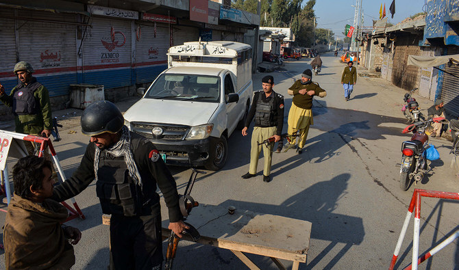 Police stand guard along a road they blocked after Taliban militants seized a police station in district Bannu, Pakistan, on December 19, 2022. (AFP/File)