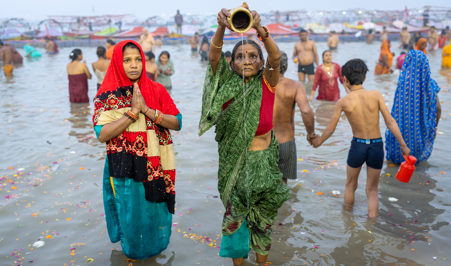 Hindu devotees pray before taking a dip at the confluence of the Ganges, the Yamuna and the mythical Saraswati rivers on the first day of the 45-day-long Maha Kumbh festival in Prayagraj, India, on January 13, 2025. (AP)