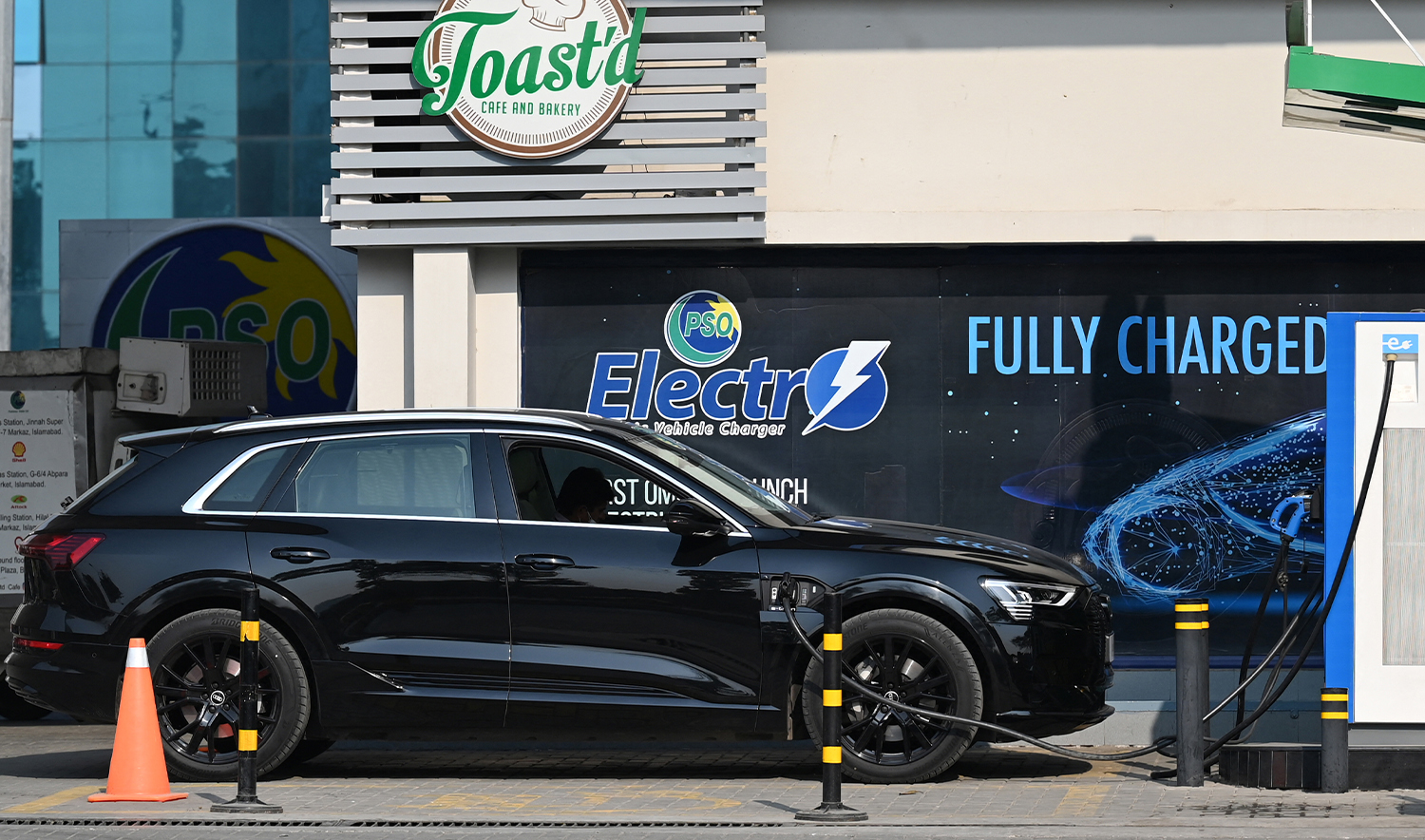 An electic car is being charged at a charging station in Islamabad on February 16, 2022. (AFP/File)