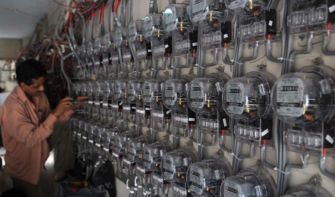 A technician from the Karachi Electric Supply Corporation (KESC), Pakistan's largest city's power supply company, fixes new electricity meters at a residential building in Karachi on May 13, 2010. (AFP/File)