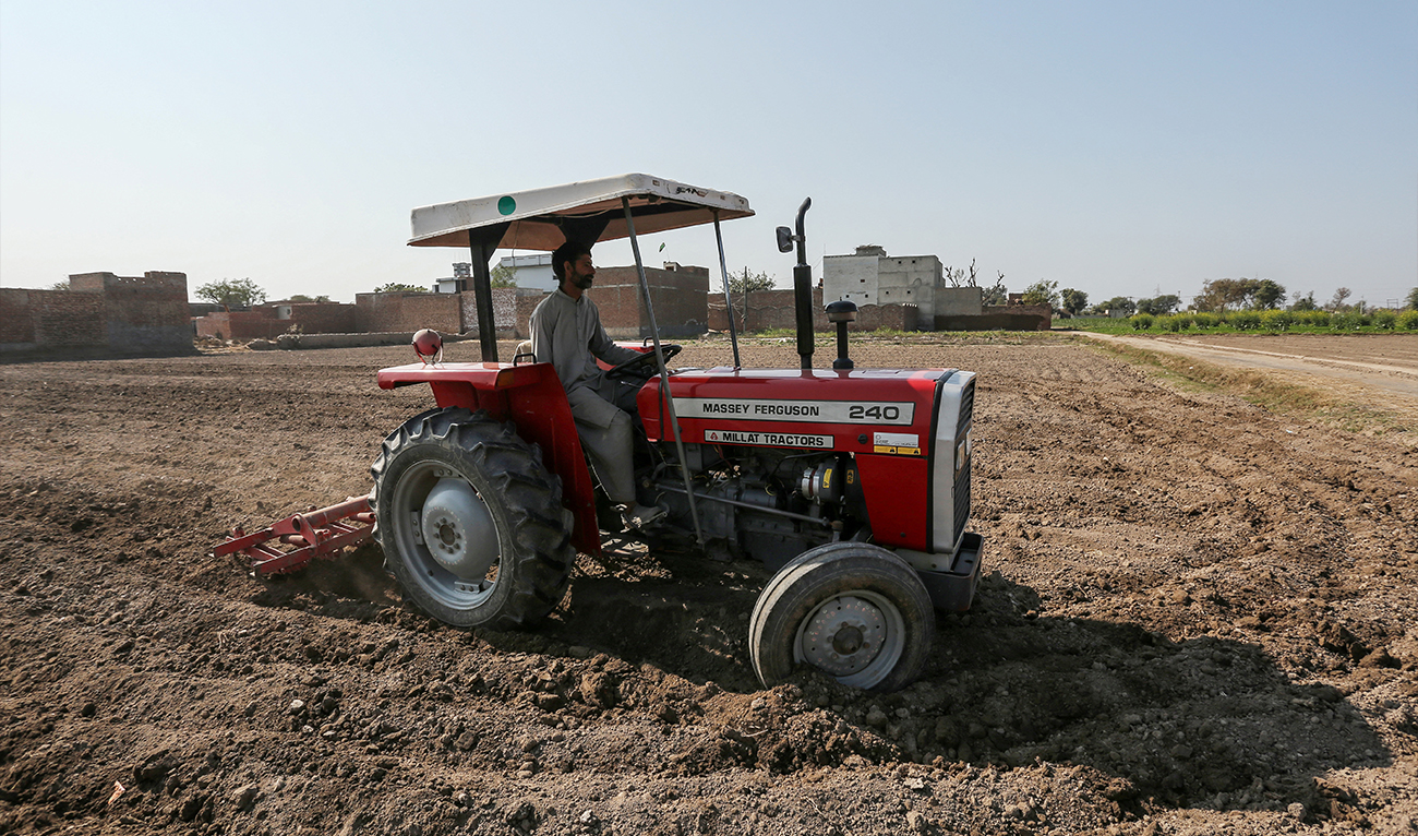 A farmer plows a field using a tractor in Multan, Pakistan, on January 23, 2025. (AFP)