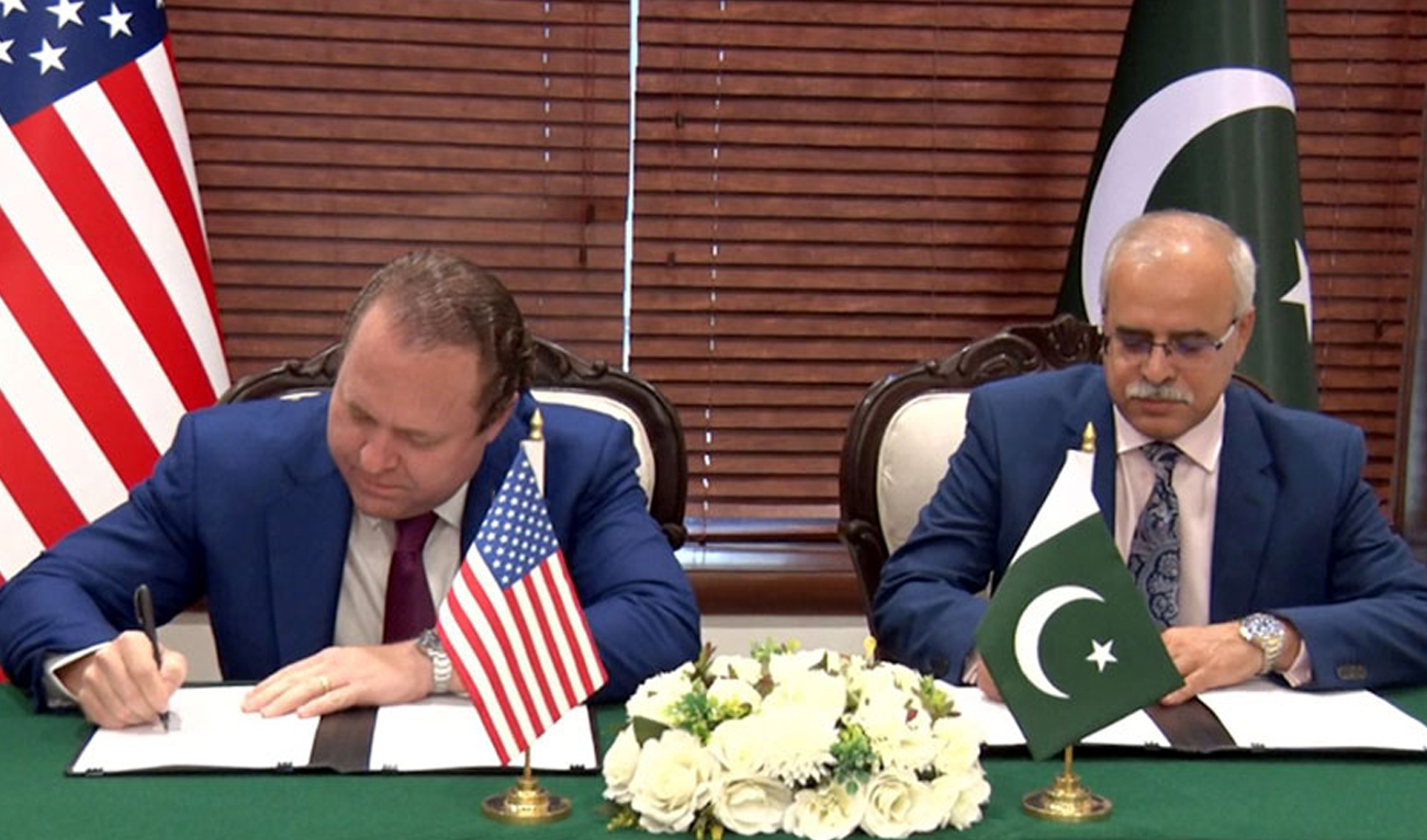 This photo, released by Radio Pakistan on January 29, 2025, shows US businessman and Texas hedge fund manager Gentry Beach (L) signing an agreement with Pakistani official in Islamabad. (Radio Pakistan)