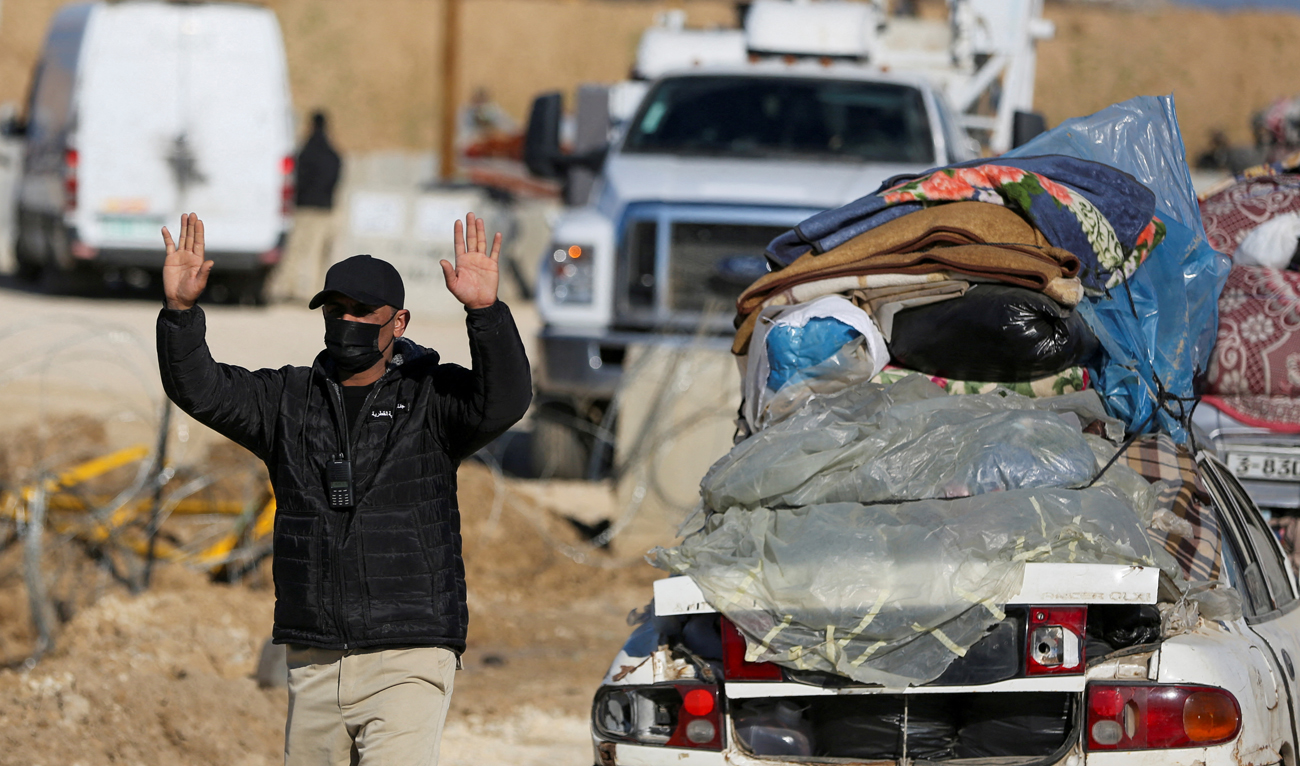 A member of the Egyptian-Qatari committee gestures while inspecting vehicles carrying Palestinians, displaced to the south by Israel’s order during the war, as they return to their homes in northern Gaza amid a ceasefire between Israel and Hamas, near Gaza City on January 27, 2025. (REUTERS)