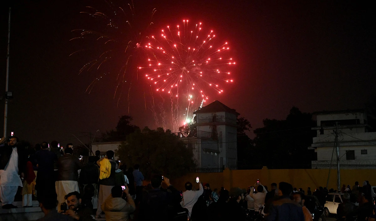 People watch fireworks during the New Year celebrations in Karachi on January 1, 2025. (AFP)