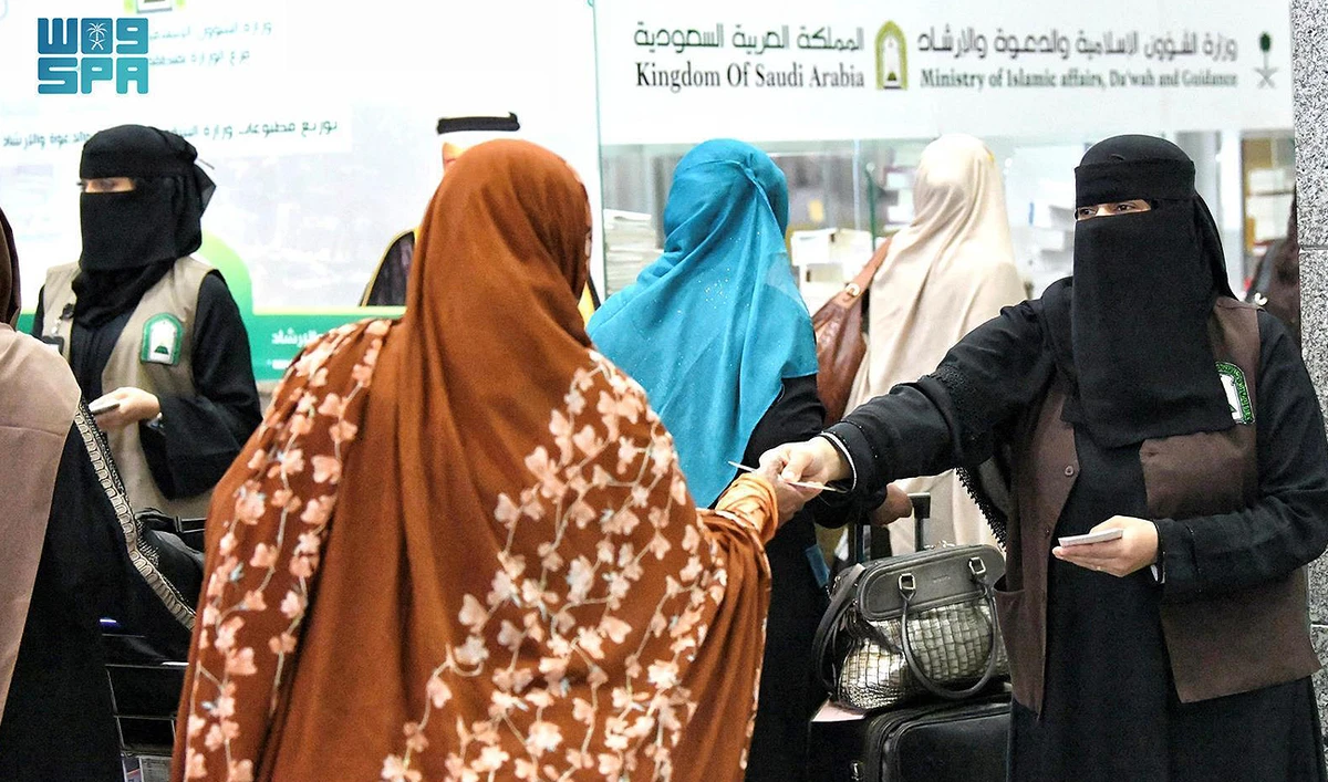 In this handout photo, taken and released by the Saudi Press Agency, Saudi Arabia’s Islamic Affairs Ministry officials receive Pakistani pilgrims at the King Abdulaziz International Airport in Jeddah on May 30, 2024. (SPA/File)