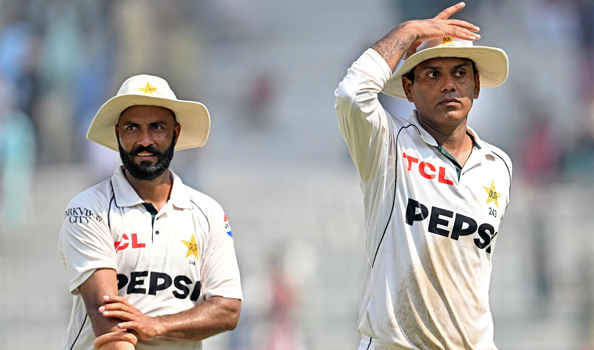 Pakistan's Noman Ali (R) and Sajid Khan (L) walk back after winning the second Test cricket match against England at the Multan Cricket Stadium in Multan on October 18, 2024. (AFP/File)