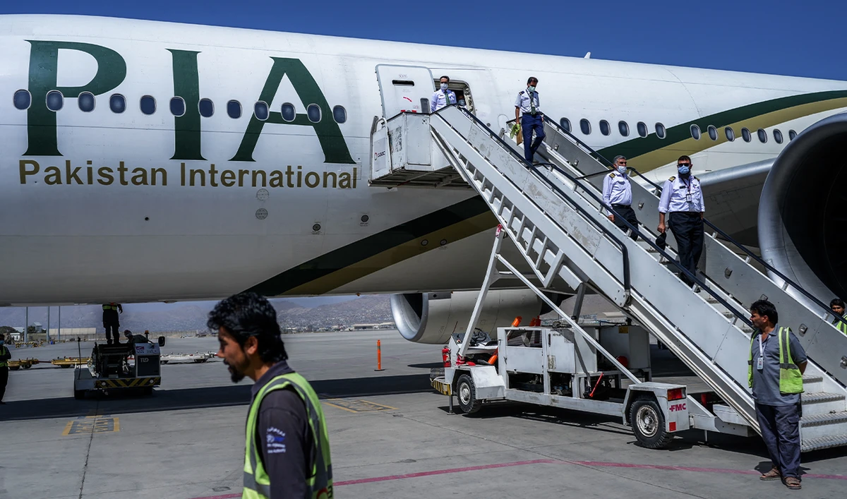 Crew members disembark from a Pakistan International Airlines (PIA) flight after it lands at the Kabul International Airport in Kabul, Afghanistan, on September 13, 2021. (AFP/File)