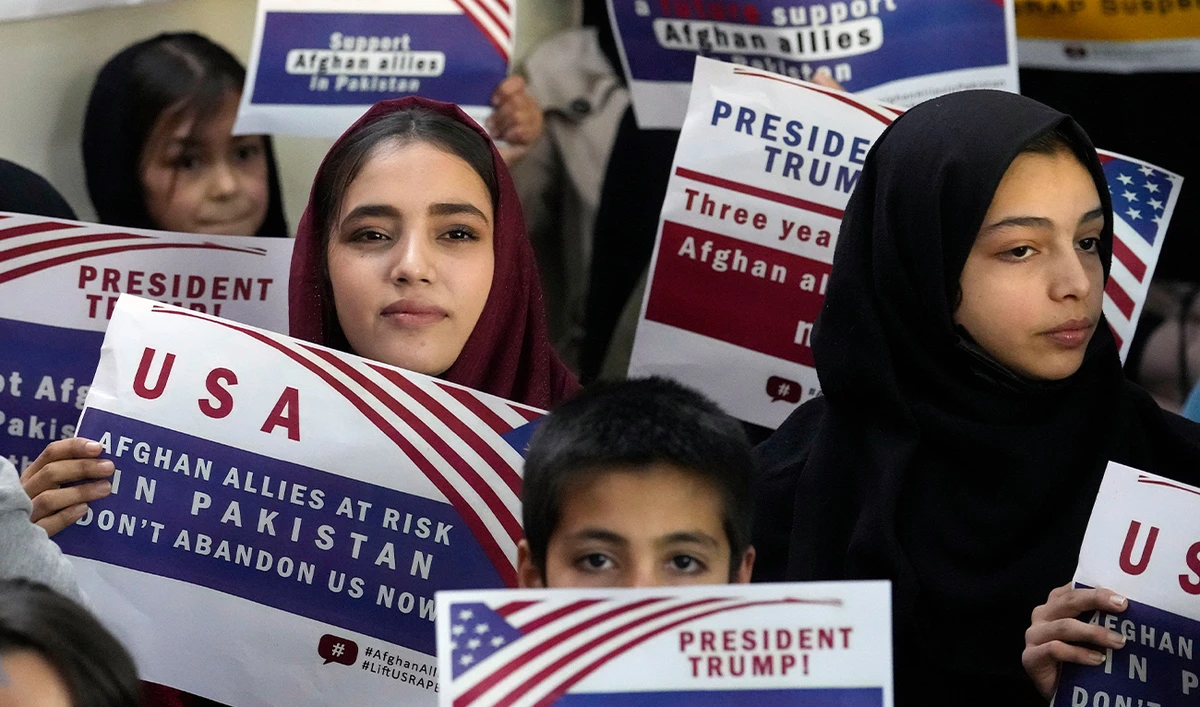 Afghan refugees hold placards during a meeting to discuss their situation after President Donald Trump paused US refugee programs, in Islamabad, Pakistan, on January 24, 2025. (AP)