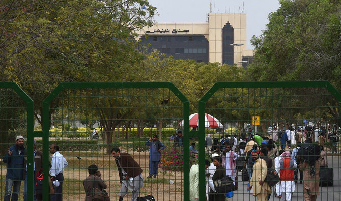 Pakistani passengers gather outside the Jinnah International Airport as they wait for flight operations to resume in Karachi on March 1, 2019. (AFP/File