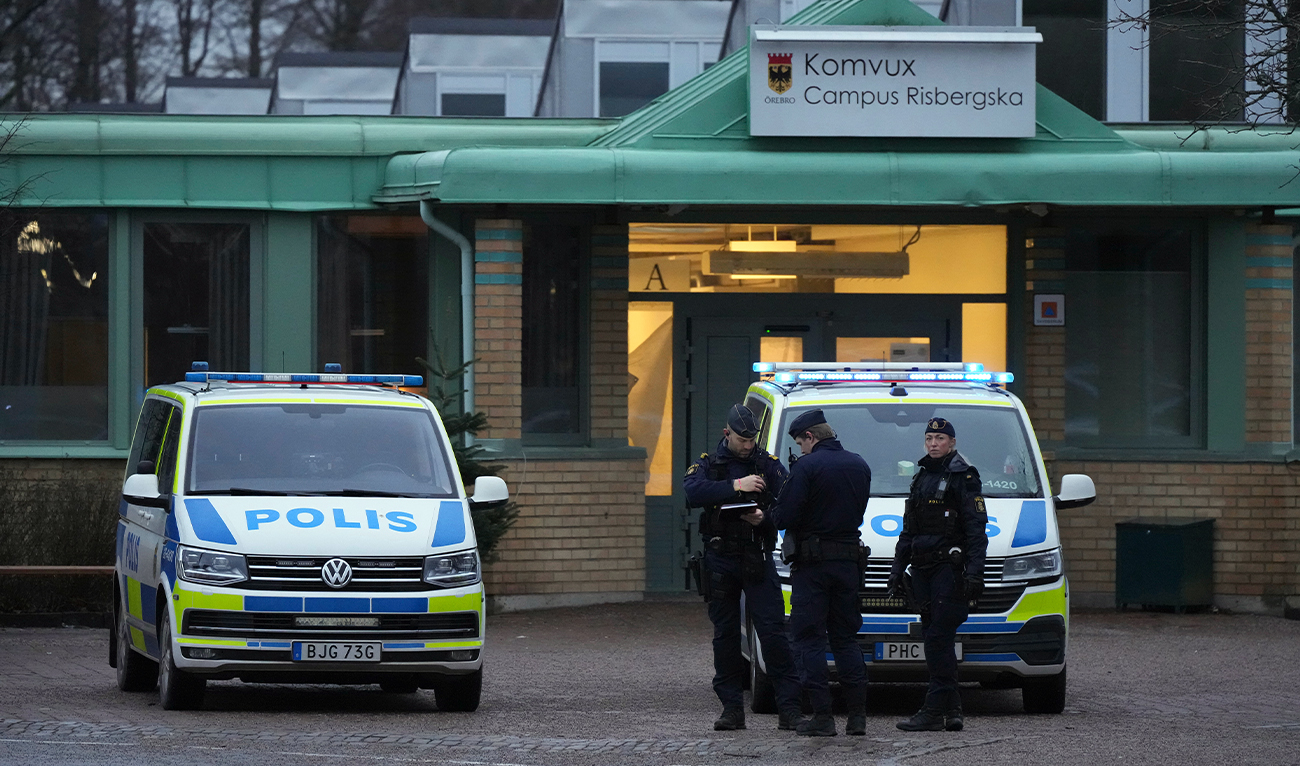 Police officers stand guard near the scene of a shooting at an adult education center on the outskirts of Orebro, Sweden, on February 5, 2025. (AP)