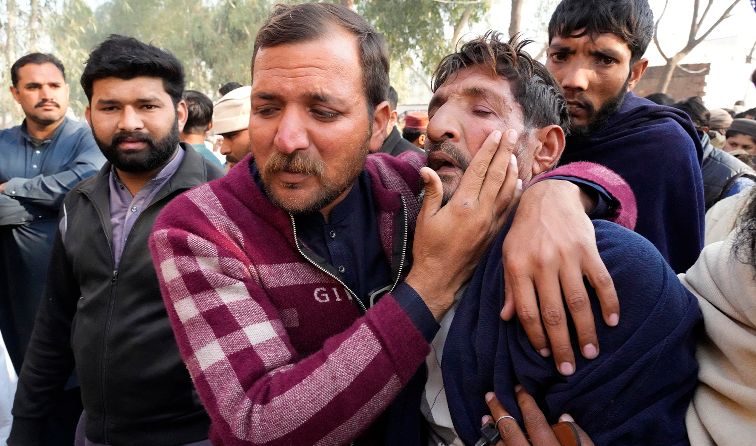 Ramzan Khan, second right, father of Muhammad Arslan, a victim of last month's migrant boat capsizing off West Africa's Atlantic coastline, is comforted by his elder son before a funeral prayer of Arslan, in Mirza Virkan village, in the Sheikhpura district, Pakistan, on February 6, 2025. (AP)