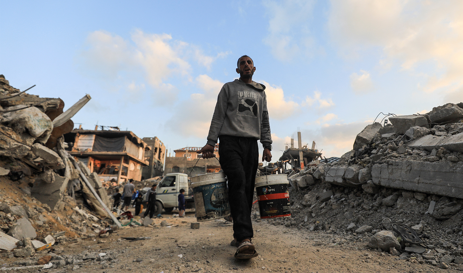 A Palestinian carries water amid a ceasefire between Israel and Hamas, in Jabalia refugee camp in the northern Gaza Strip on February 4, 2025. (REUTERS)